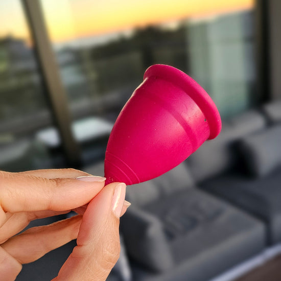 Woman holding Gentle Day menstrual cup
